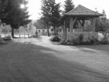 Landscapped open space with rock walled gazebo