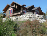 Boulder retaining wall with natural vegetation