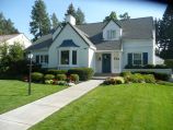 Front yard and cement walkway with manicured ground cover