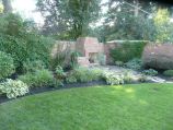 Red brick garden wall with matching fireplace