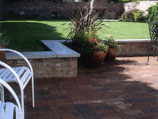Red clay paver patio with brick wall
