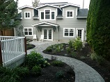 Stone paver pathway connected to stone patio