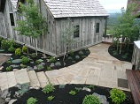 Flat rock pathway and steps between building