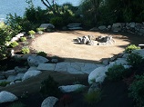 Firepit rock ring on landing with lake overlook