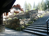 Concrete stairs next to multi-tier retaining wall