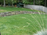 Fitted rock wall separating layers of lawn