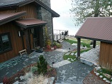 Multiple tier paver pathway leading to deck