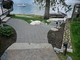 Stone paver lighted pathway down to the water and dock