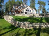 Grass softscape separated by rock retaining wall hardscape