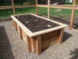 Raised, wooden garden boxes with drip irrigation