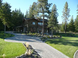 Front lawn with paver walkway, flowerbeds, accent wall and lighting