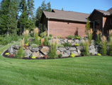 Natural boulder retaining wall with ground cover