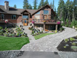 European paver driveway and stone steps with water feature