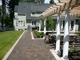 Lawn up to concrete edging with patio and garden beds