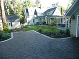 Paver driveway with parking space in front of the garage