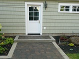Concrete edged paver path and step to garage