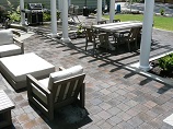 Patio pavers with concrete edging and white concrete pillars