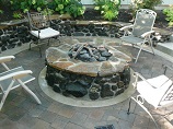 Sunken gas stone firepit with matching stone retaining wall