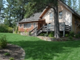 Sandpoint timber frame house, deck, and naturalistic landscape