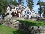 Ledge stone retaining wall with lush lawn landscaping