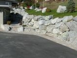 Driveway lined with natural rough granite boulders and granite steps