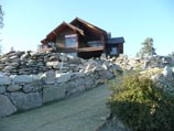 Walking path with natural granite boulder retaining wall