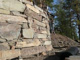 Curved retaining wall using naturally stacked stone quarried in Clark Fork