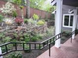 Side yard retaining wall with natural wall cover