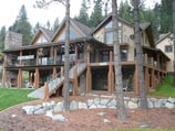 Concrete edged lawn with small, natural, broken granite stone wall