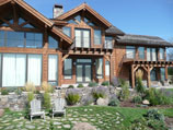 Flower beds and ground cover fronting drystacked rock wall