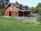 Fenced horse pasture and stable