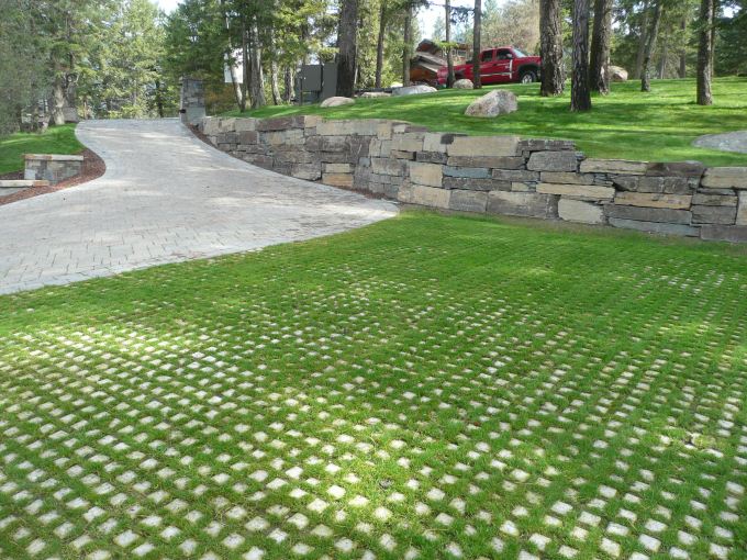 Similar to prior image, this is a photograph of the pavers used as a parking lot in a place resembling a park or posh neighborhood.