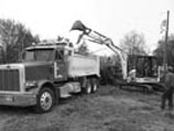 Loading and hauling excess material from a construction site