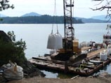 Difficult work site requiring material tranfer via a barge