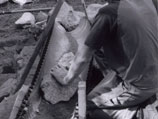 Working with gravity to move materials while building a rock retaining wall